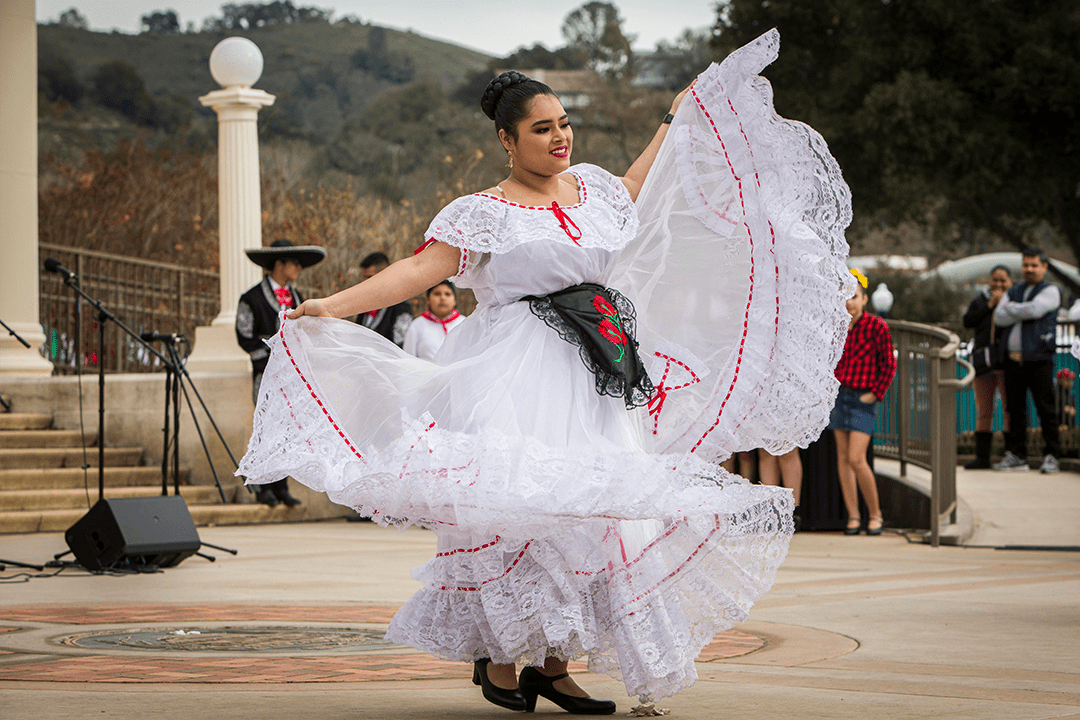 Image of Folkloric Dancer in a white traditional dress dancing in front of Atascadero City Hall - Photo by Keith Bergher